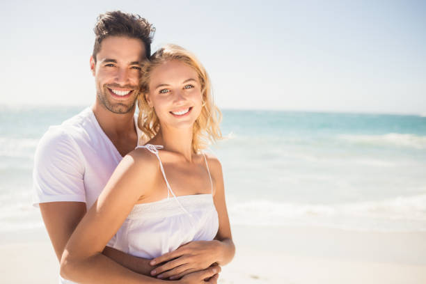 istock Smiling young couple hugging 698318762