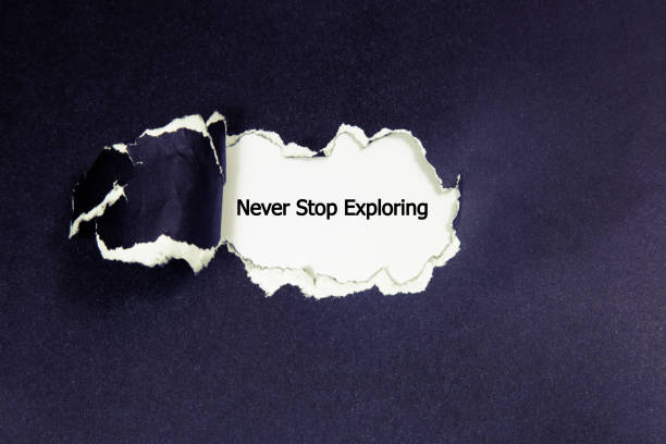 istock The word never stop exploring appearing behind torn paper. 698324792