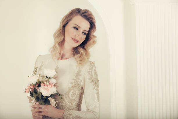 istock Studio shot of young beautiful bride with corsage 698345154
