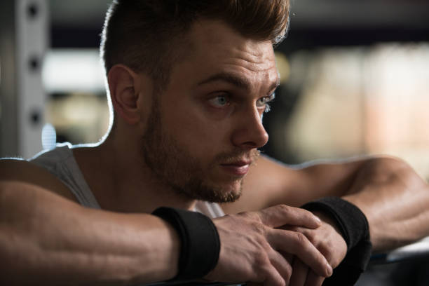 istock Attractive Young Man Resting In Gym Afther Exercise 698345598