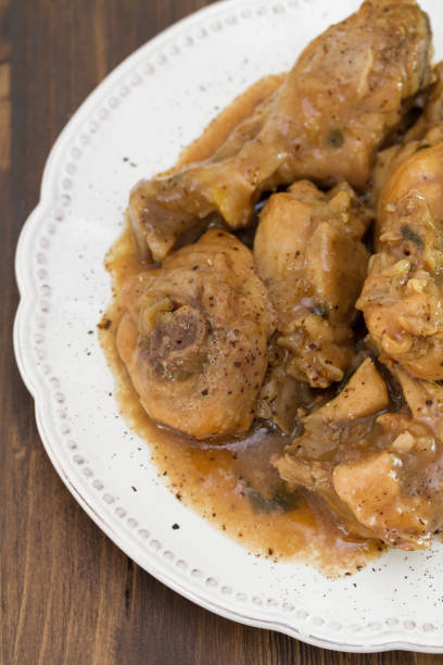 istock boiled chicken with sauce in white plate on brown wooden background 698348506