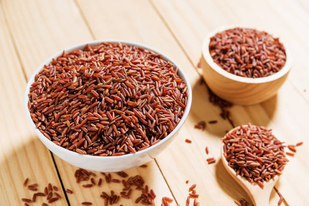 istock Rice berry in white bowl on wooden background 698354928
