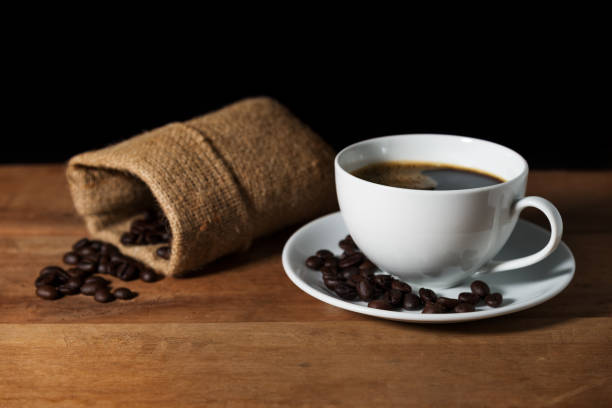 istock Coffee cup with coffee bean on brown wooden table 698354996