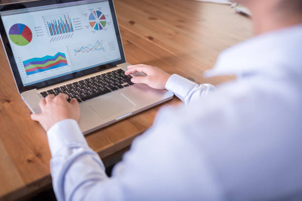 istock asian business man looking report on laptop 698360538