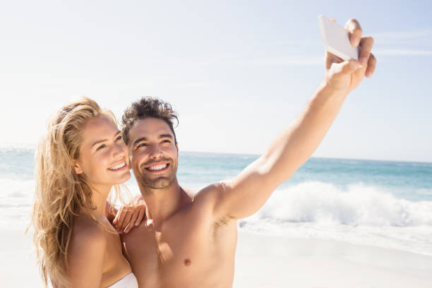 istock Smiling couple taking selfie 698367646