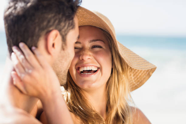 istock Young couple sitting on sand 698371470