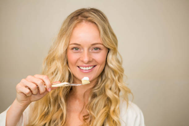 istock Beautiful blonde about to brush her teeth 698377840