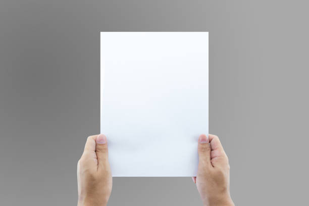 istock Hands holding paper blank a4 size for letter paper. 698388920