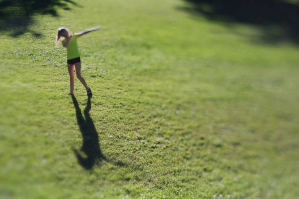istock Preteen Girl Making Shadow on Grass 698406176