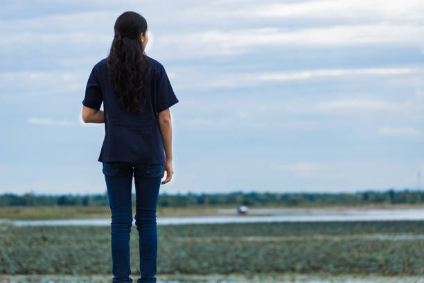 istock Asian girl standing on jetty 698411166