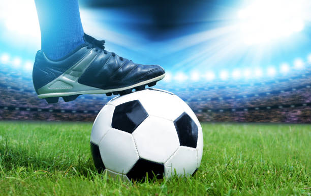 istock Feet of soccer player with ball 698418764