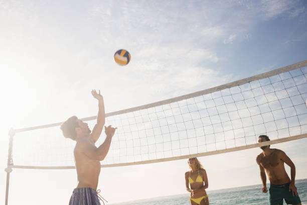 istock Friends playing beach volleyball 698418856