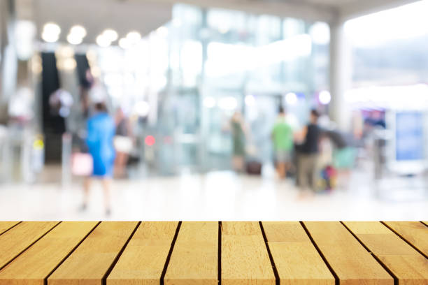 istock Perspective empty wooden table over blurred shopping mall background, for product display montage or design layout. 698421454