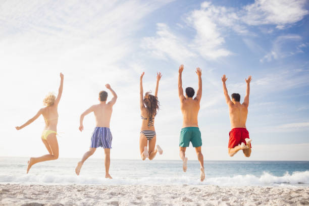 istock Happy friends jumping together 698444306