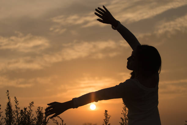 istock Silhouette of a young asian woman 698446044