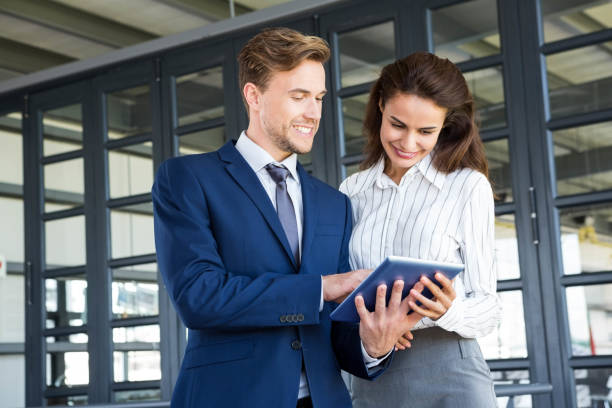 istock Businessman and businesswoman using digital tablet 698450614