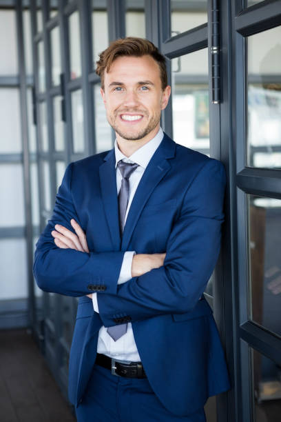 istock Businessman standing with arms crossed 698450854
