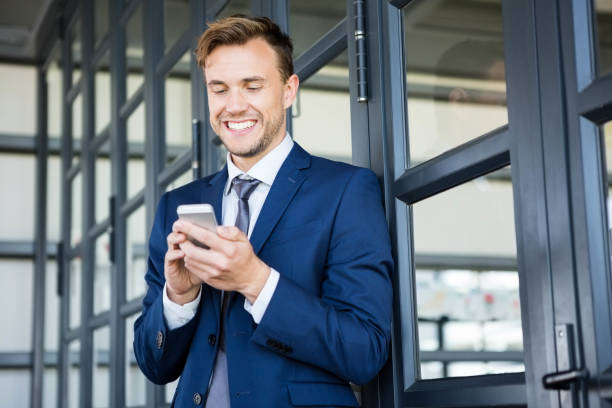 istock Businessman text messaging on smartphone 698450866