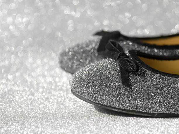 istock Black and white ballet shoes with glitter background. 698467288