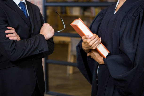 istock Lawyer holding a law book 698476258
