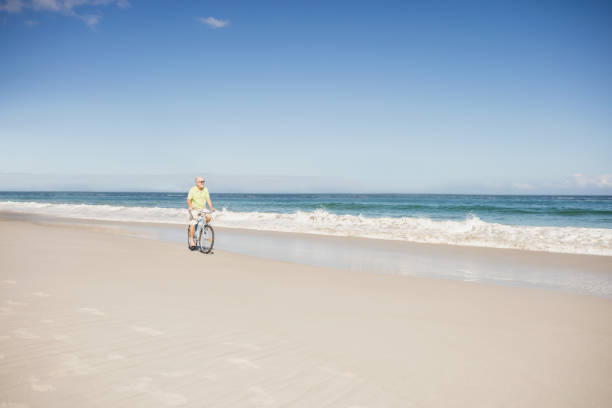 istock Smiling senior man riding bike 698477078