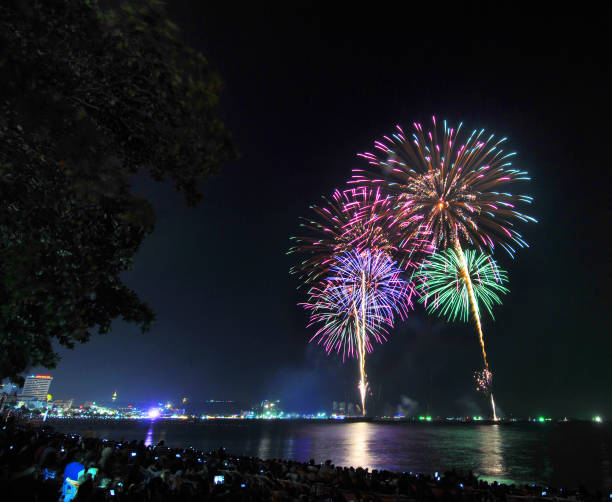 Multicolor fireworks night scene Multicolor fireworks night scene, closeup with pattaya cityscape sea beach view, thailand phuket beach party stock pictures, royalty-free photos & images