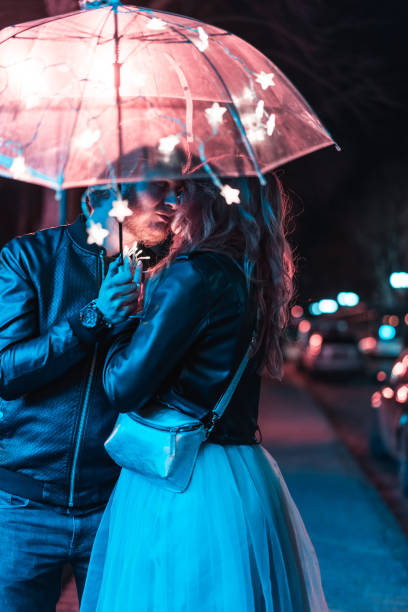 istock Guy and girl kissing under an umbrella 698490800