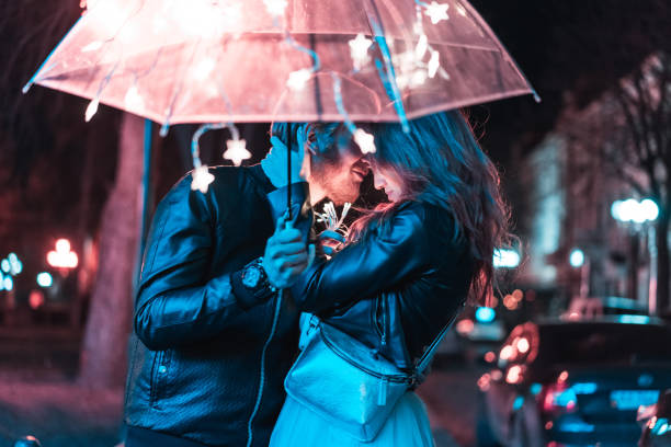 istock Guy and girl kissing under an umbrella 698491382