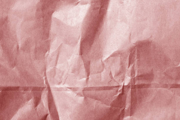 istock wrinckled red color paper surface. 698496300