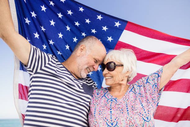 istock Senior couple holding american flag together 698501562