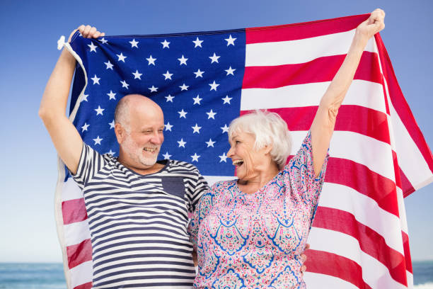 istock Senior couple holding american flag together 698501584