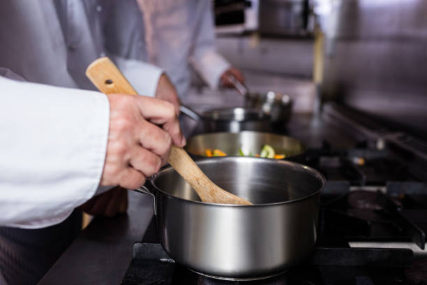 istock Close-up of chef preparing food 698502042