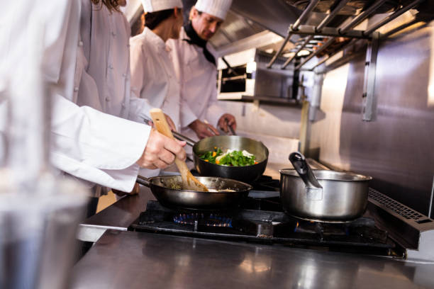 istock Group of chef preparing food in the kitchen 698507152