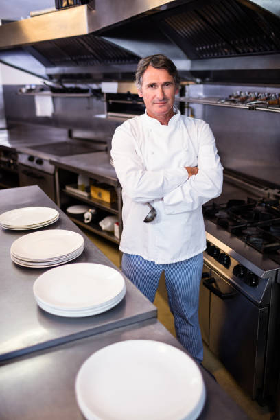 istock Smiling chef with hands crossed in the kitchen 698507336