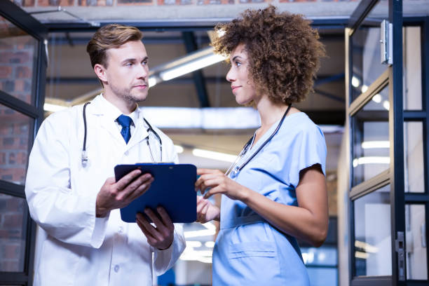 istock Doctors discussing the report on clipboard 698507394
