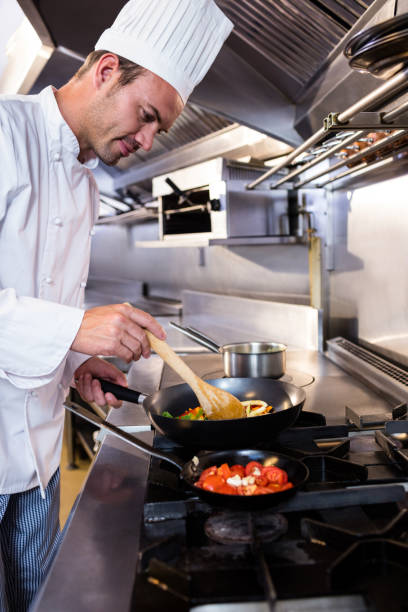istock Chef preparing food in the kitchen 698507652