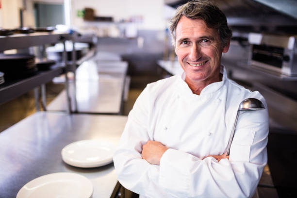 istock Smiling chef holding ladle in the kitchen 698508924