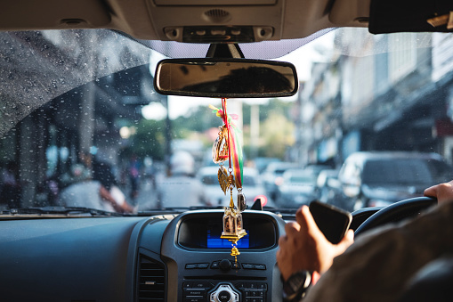 Modern Car Interior With Hanging Amulets Charm On Rear View Mirror