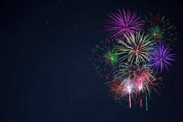 istock Purple lilac red green celebration fireworks copy space. 698520358