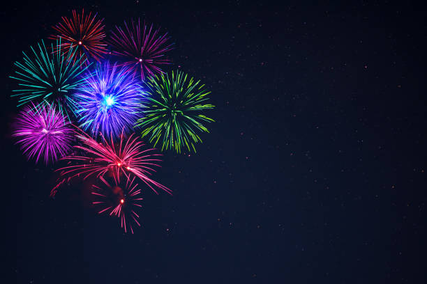 istock Pink purpe blue green fireworks over night sky 698520412