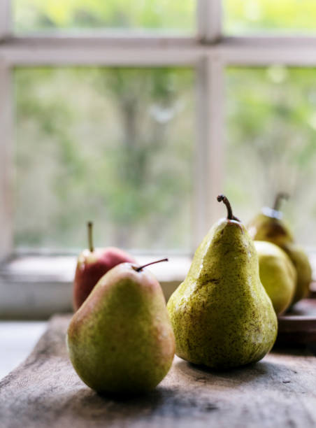 istock Closeup of fresh pears on wooden table 698522812