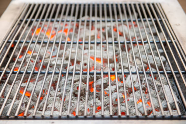 istock burning charcoal with grill plate for BBQ 698523694