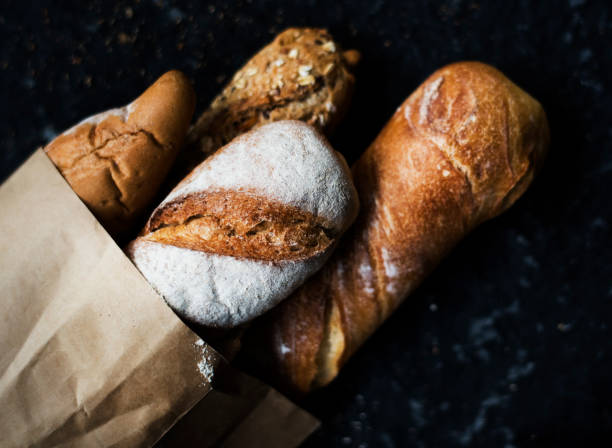 istock Baguettes on paper bag with black background 698524248