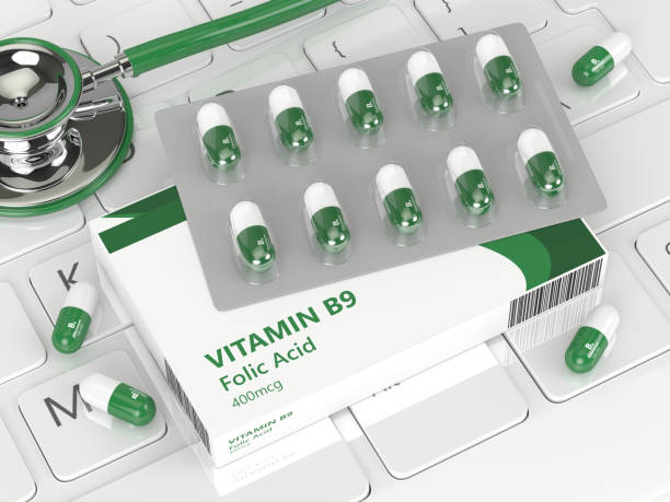 3d render of B9 folic acid pills lying on keyboard 3d render of B9 folic acid pill  lying on keyboard in office folic acid stock pictures, royalty-free photos & images