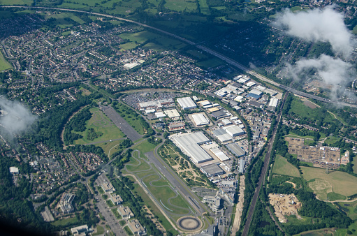 Aerial view of the historic Brooklands Racing Circuit - the first to be purpose built in the world, Weybridge, Surrey.  The former aerodrome and plane manufacturing base is now home to a transport museum, some manufacturing and retail companies.