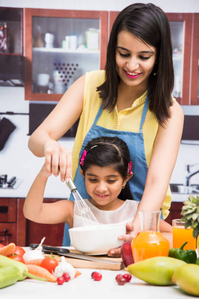 istock indian mother and child in kitchen 698533898