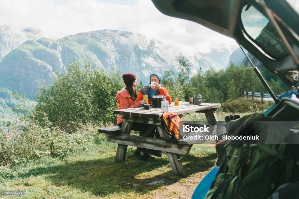 Couple have breakfast in mountains in Norway Young Caucasian couple have breakfast in mountains in Norway Car Stock Photo