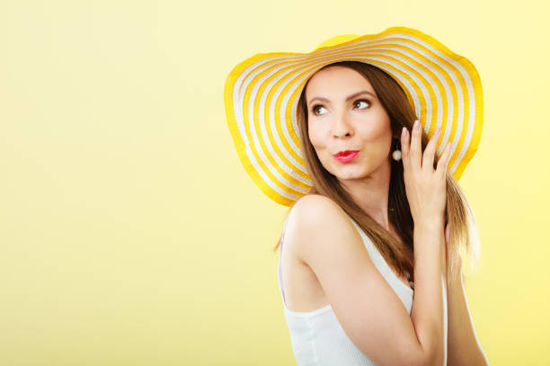 istock Woman in big yellow summer hat. 698534960