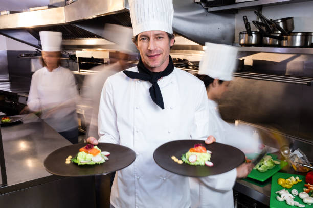 istock Happy head chef presenting his food plates 698535900