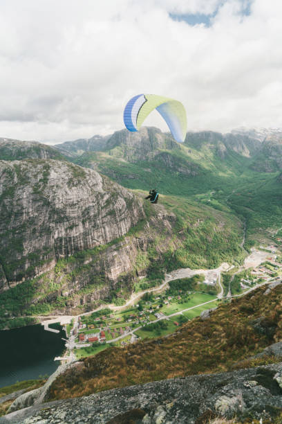 istock Person paragliding in mountains in Norway 698540520